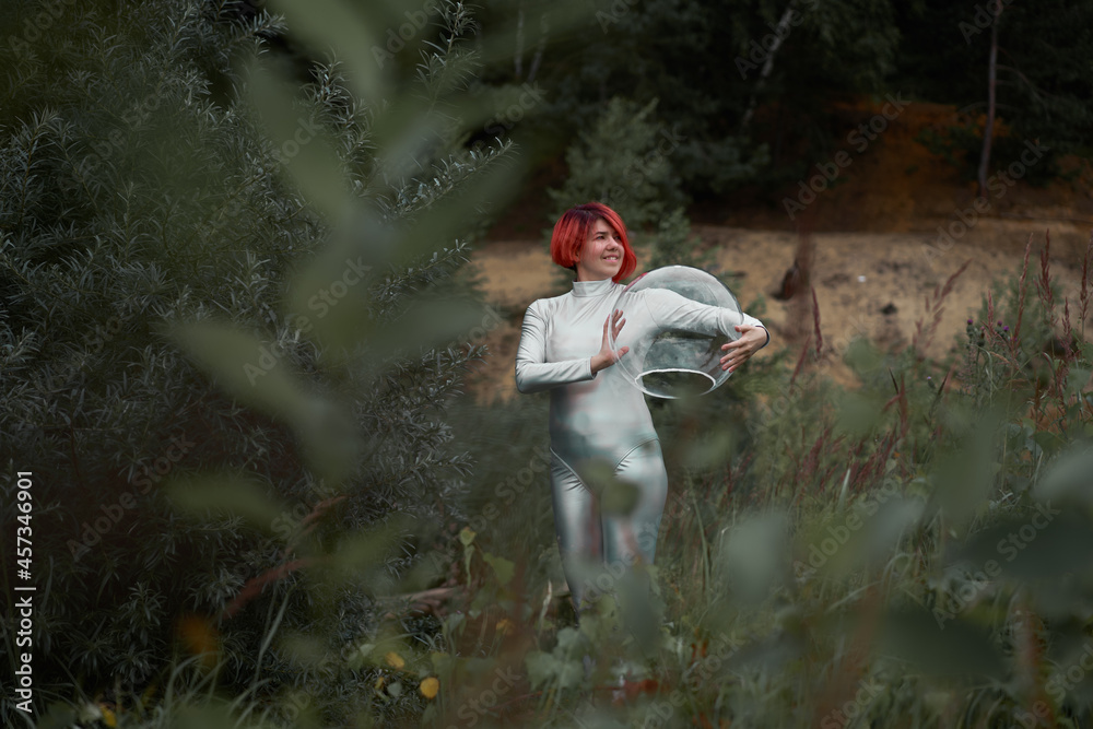 Woman in space suit walking in field Woman in space suit walking in field
