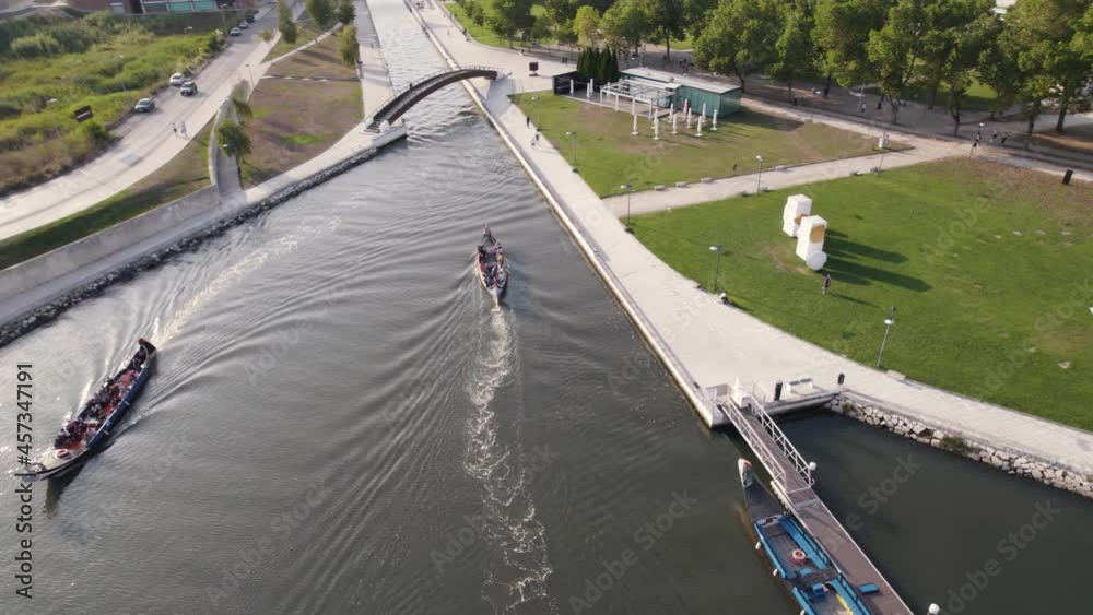 Canoeing in water canal near city of Aveiro, aerial orbit view Canoeing in water canal near city of Aveiro, aerial orbit view