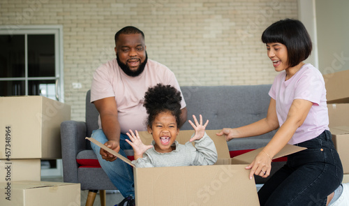 Mixed Race families are sitting on the sofa for rest after moving to a new house on the first day after buying real estate.  Concept of starting a new life for a new family. © Prot