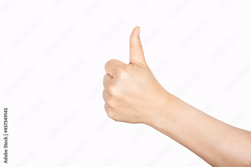 Closeup of female hand showing thumbs up sign against white background.