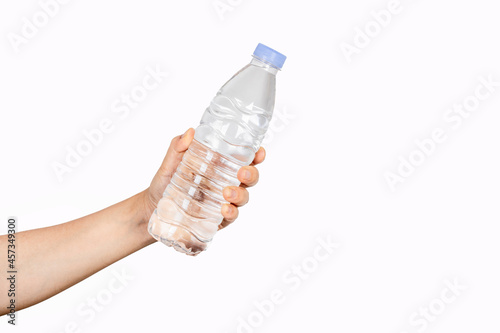 Close-up of a woman holding a bottle of water or mineral water isolated on a white background