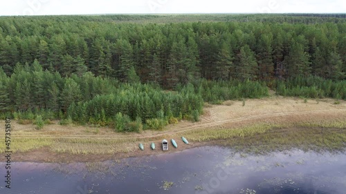 Flight over the taiga forest lake