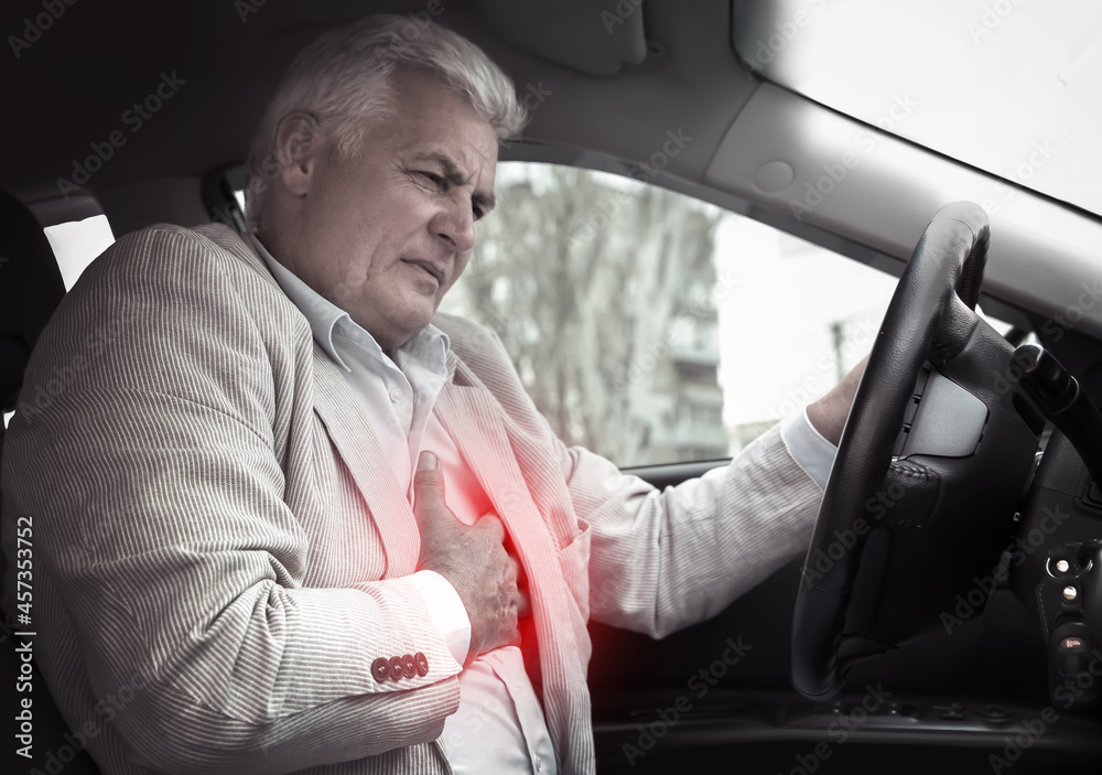 Senior man having heart attack in car Senior man having heart attack in car