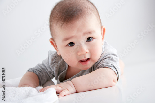 Cute Asian baby playing on the ground