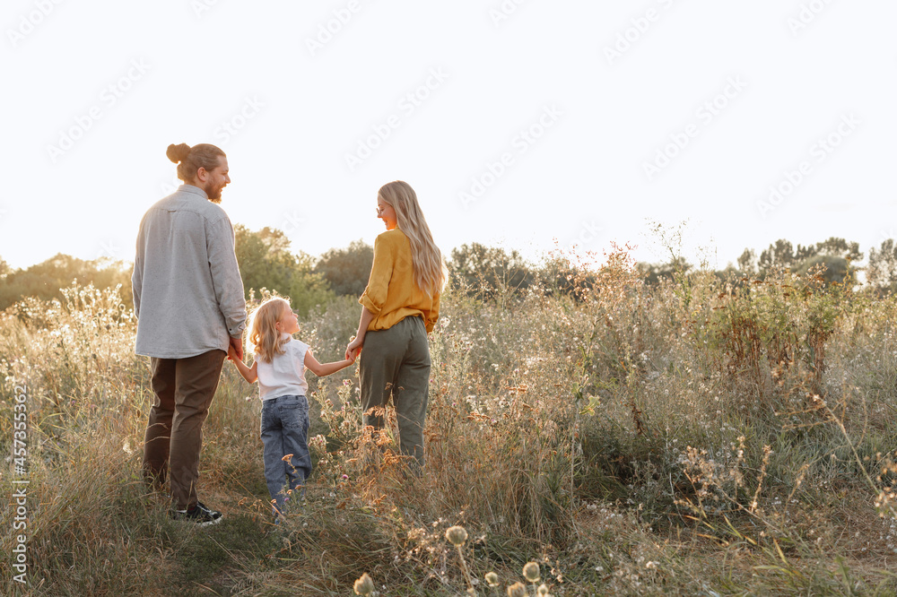 happy family on a walk together at sunset. child protection happy family on a walk together at sunset. child protection