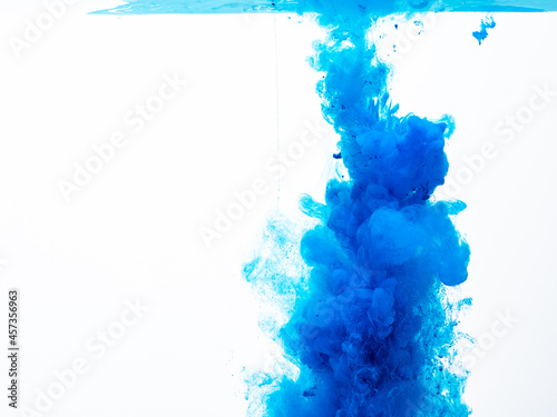 splash and blur of colored paint underwater on white background