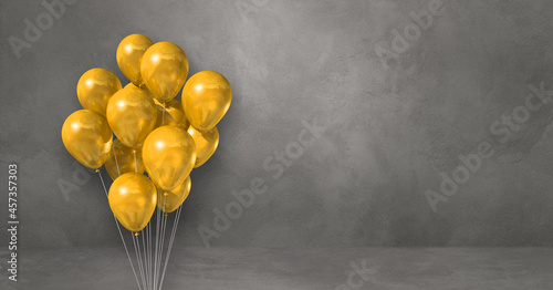 Yellow balloons bunch on a grey wall background. Horizontal banner.