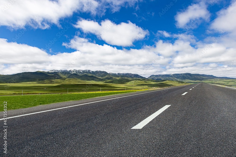 Fototapeta premium Tarmac road under blue sky