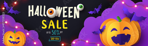 Halloween Promotion banner with cutest pumpkin and bats in night clouds on violet black background. Paper cut style. Halloween website Sale banner or header, horizontal poster template