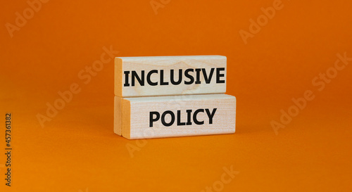 Inclusive policy symbol. Wooden blocks with words Inclusive policy on beautiful orange background. Business, HR and inclusive policy concept. Copy space.