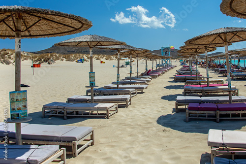 Beach umbrellas and deckchairs at the seaside in summer