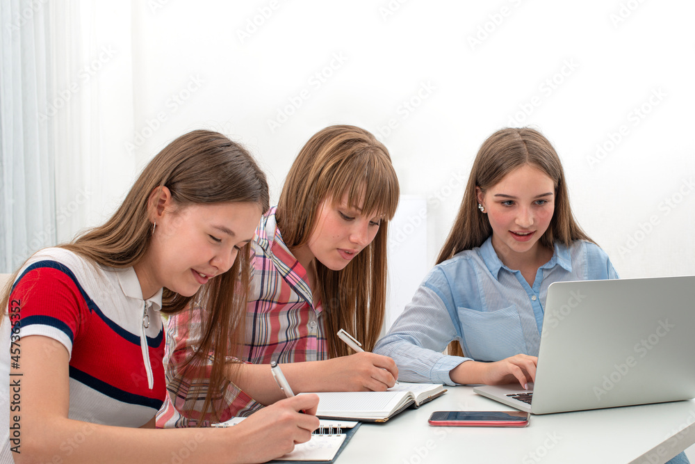 Focused students sitting at desk studying together. Focused students sitting at desk studying together.