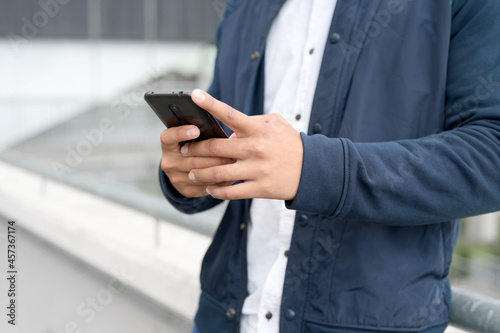 Close up Man texting on cell phone. High quality photo.
