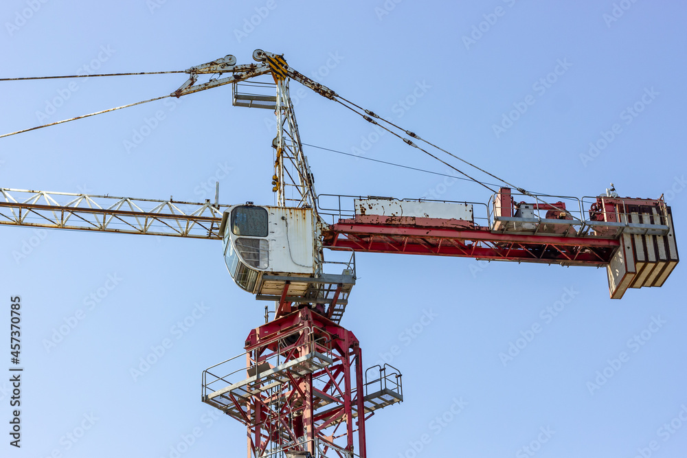 Construction crane on the background of the sky. Tower crane. Construction machinery. Construction crane on the background of the sky. Tower crane. Construction machinery.