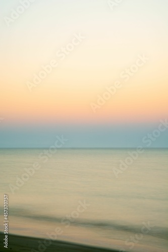 relaxing long exposure showing the sea at sunrise. Gold ocean beach sunrise.