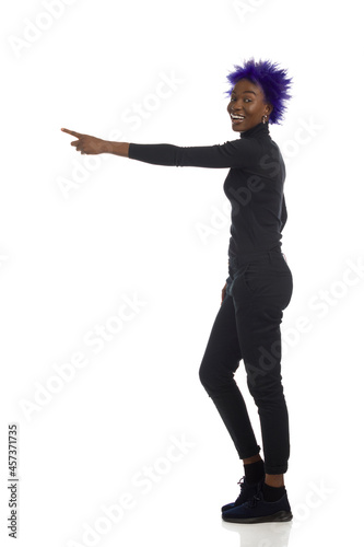 Happy Young Black Woman Is Standing And Directing. Full Length, Isolated.