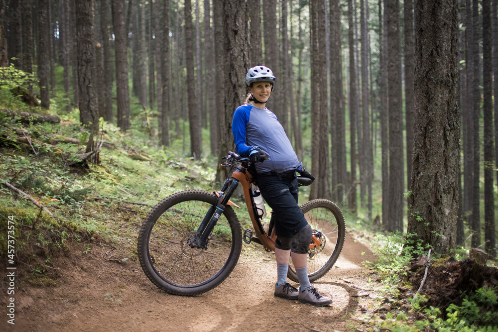 A pregnant young woman enjoys mountain biking in the Columbia River Gorge of Oregon. A pregnant young woman enjoys mountain biking in the Columbia River Gorge of Oregon.