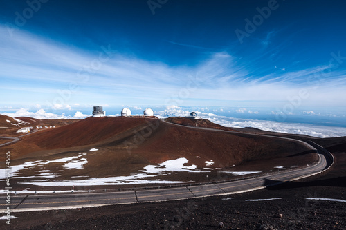 telescopes and road on barren moonscape of Mauna Kea summit, Hawaii