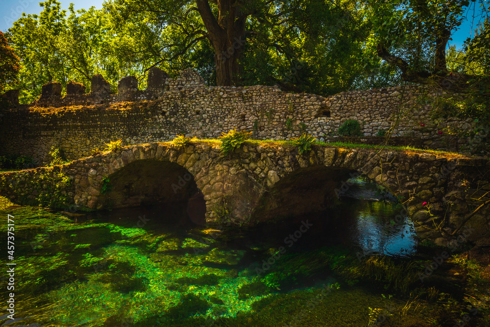 Fototapeta premium Medieval ruins in an enchanted garden, Giardini di Ninfa, Latina, Rome