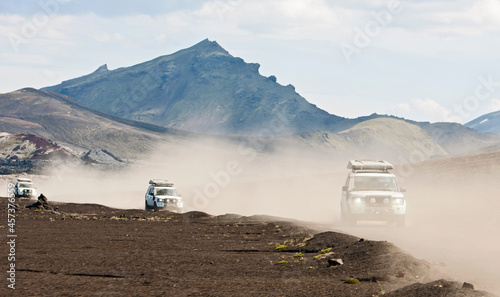 SUV's driving through the dusty interior of Iceland