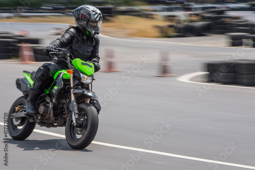 Woman practising on her motorbike at race track in Bangkok