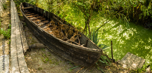 old wooden boat on the backyard photo