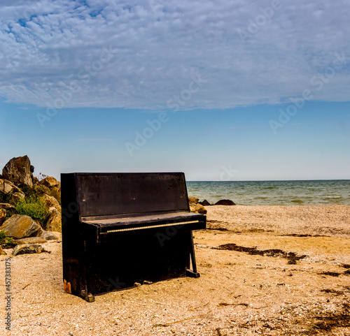 old piano on the sea beach