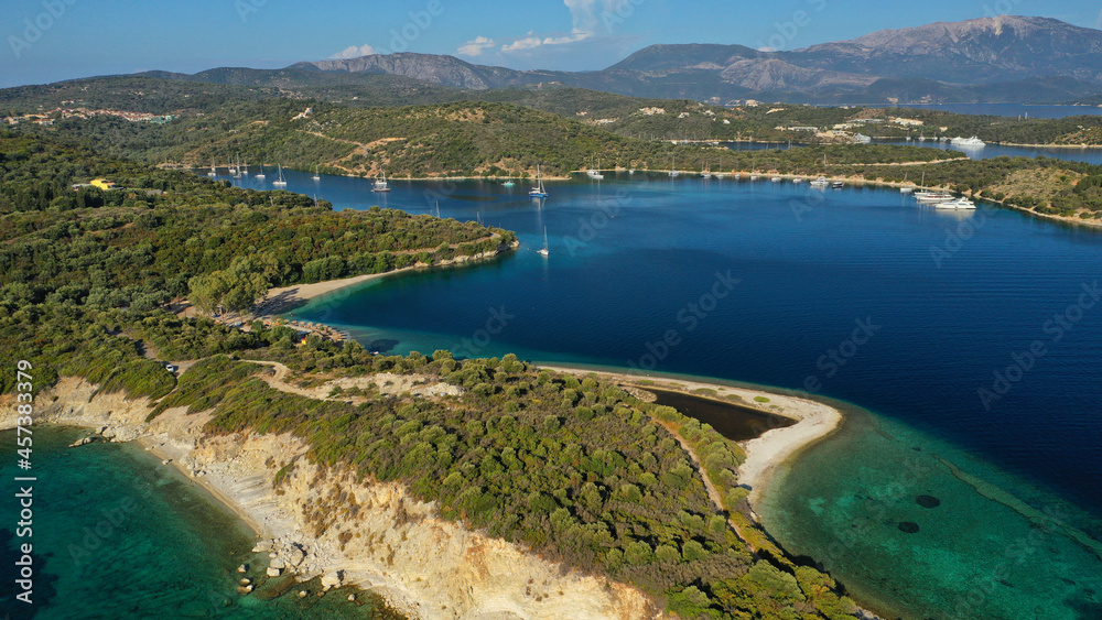Aerial drone photo of organised with sunbeds and umbrelas paradise beach of Fanari with crystal clear turquoise sea, Meganisi island, Ionian, Greece