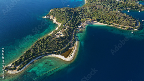 Aerial drone photo of organised with sunbeds and umbrelas paradise beach of Fanari with crystal clear turquoise sea, Meganisi island, Ionian, Greece © aerial-drone