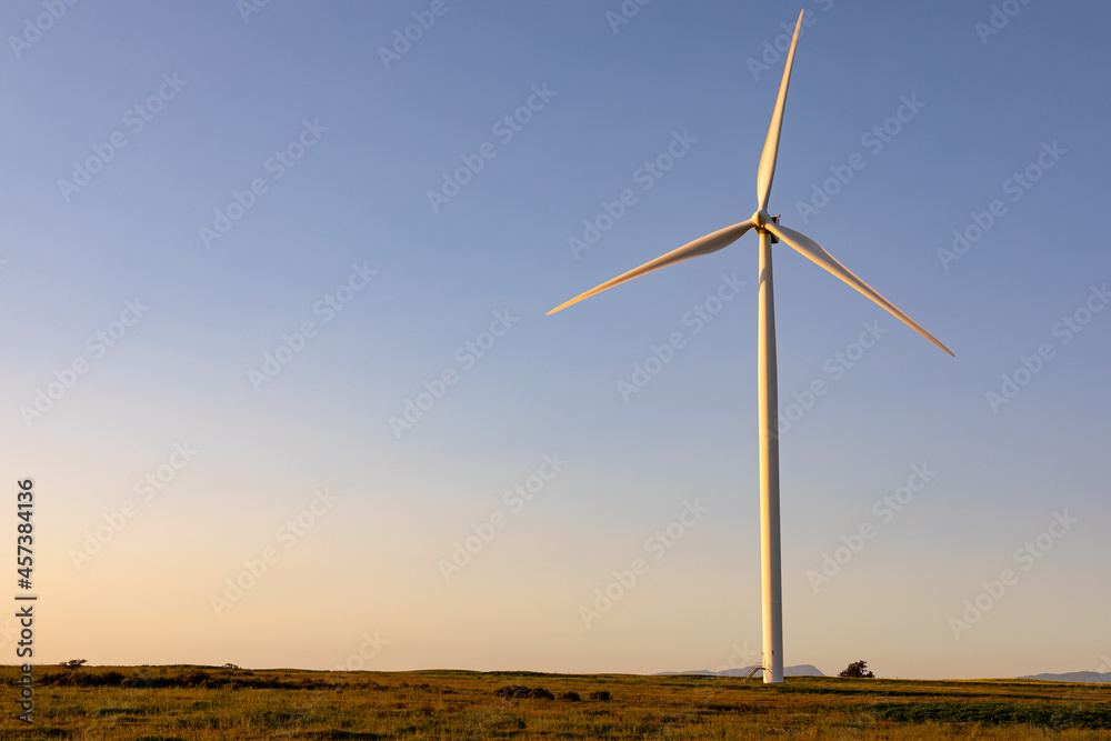 General view of wind turbine in countryside landscape with cloudless sky General view of wind turbine in countryside landscape with cloudless sky