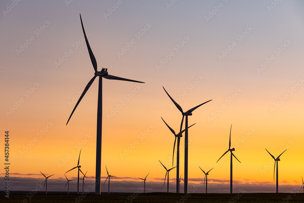 General view of wind turbines in countryside landscape during sunset