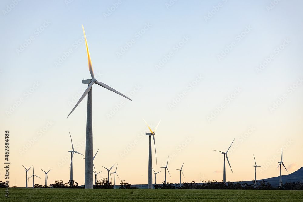 General view of wind turbines in countryside landscape with cloudless sky General view of wind turbines in countryside landscape with cloudless sky