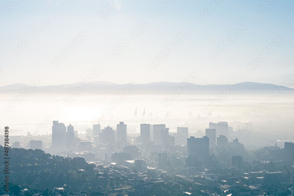 General view of cityscape with multiple modern buildings and skyscrapers in the foggy morning