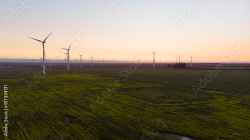 General view of wind turbines in countryside landscape with cloudless sky