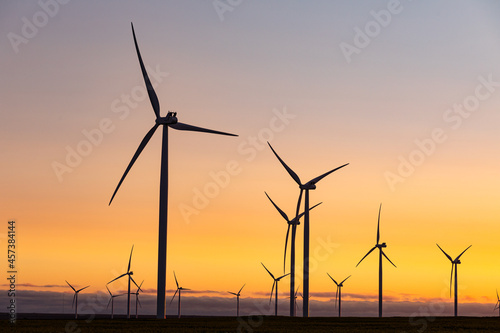 General view of wind turbines in countryside landscape during sunset