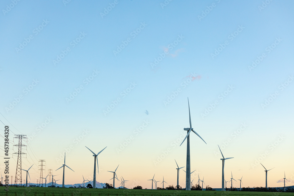 General view of wind turbines in countryside landscape with cloudless sky General view of wind turbines in countryside landscape with cloudless sky