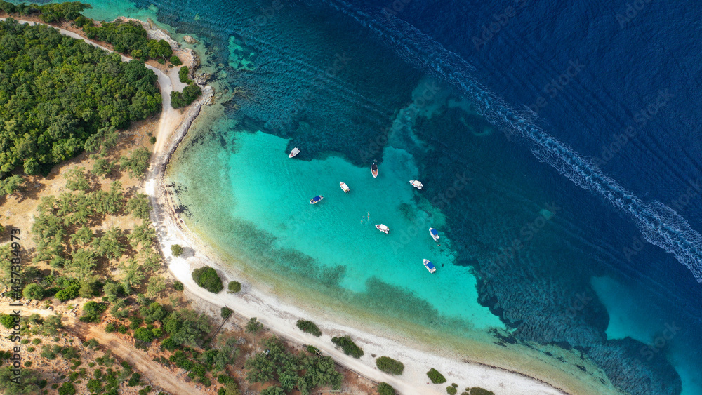 Aerial drone photo of paradise exotic azure beach of Agios Ioannis a famous yacht and sail boat visit in Ionian island of Meganisi, Greece
