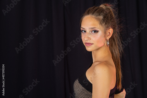 Beauty teen in black latin dance clothes. Dance Studio Template.