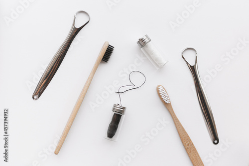 Dental hygiene set for couple. Bamboo toothbrush, dental floss and metal tongue scraper
