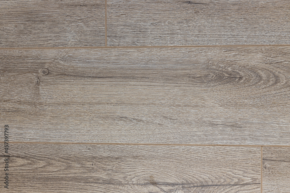 Wooden floor. Gray laminate or parquet. Rectangular board on the floor. Wood texture. Wooden floor. Gray laminate or parquet. Rectangular board on the floor. Wood texture.
