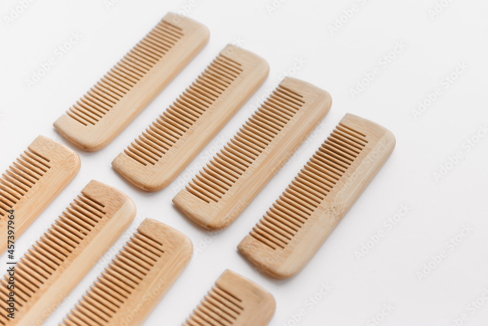 wooden combs scattered isolated on white background, flat lay, top view