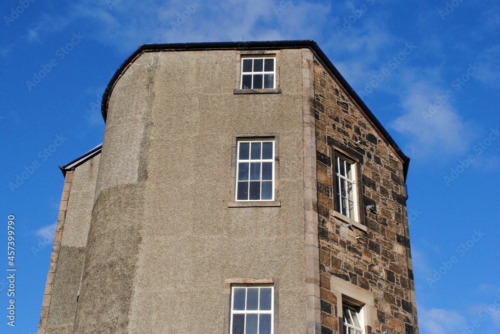 Old Stone Residential Building Seen from Below against Blue Sky 