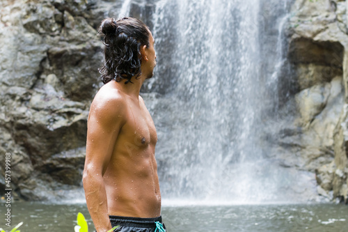 Rear view of man looking the waterfall