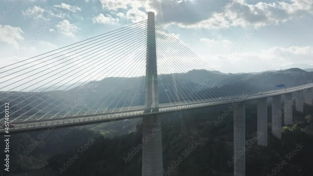 Panoramic view of high Vila Real Bridge in mountains, Portugal, Europe. Aerial shot of highway traffic moving on bridge across Corgo river. Vehicles riding on road bridge in morning light, 4k footage