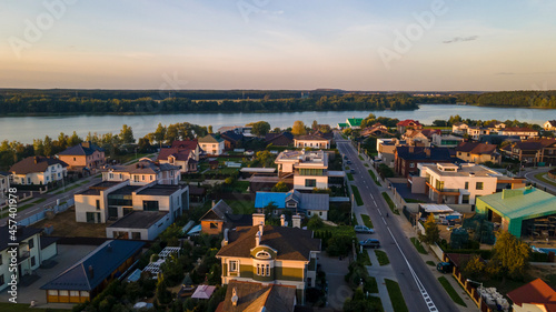 Aerialphoto suburbs of big city. Country houses, forests, lakeshore. Citylife concept.