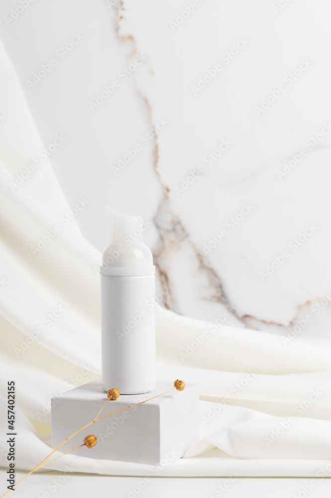 Plastic dispenser with foam on podium. Cosmetic product for skincare Plastic dispenser with foam on podium. Cosmetic product for skincare