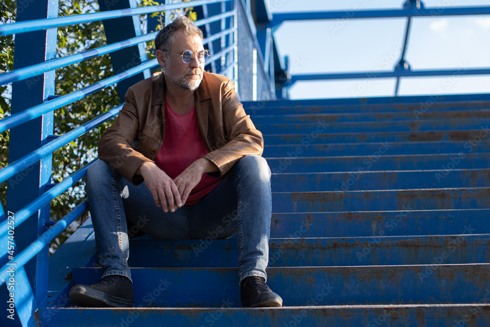 man thinking and sitting on stairs