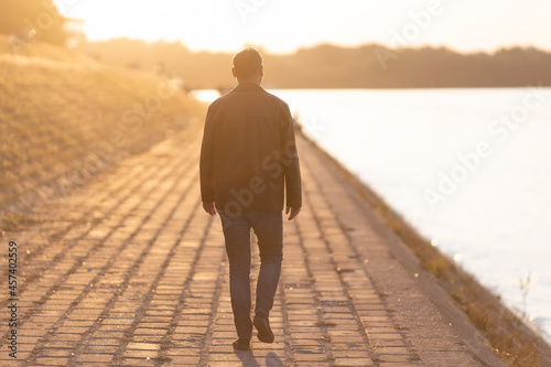 Фотография man walking away into sunset
