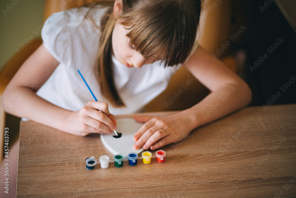 The girl paints an egg The girl paints an egg
