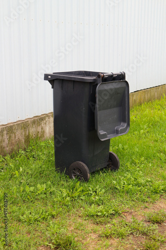 Plastic trash can on the grass . Responsible attitude to the environment.